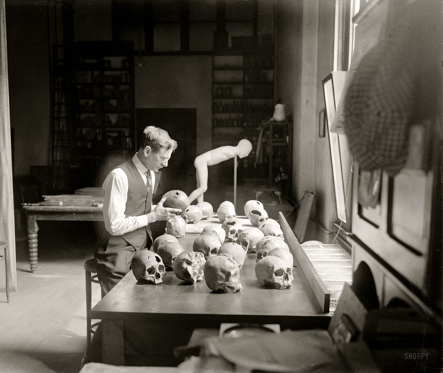 March 27, 1926. "William H. Egberts examining trepanned skulls in the anthropology laboratory at the National Museum. The crude method of trephining with the sharpened edge of a stone practiced by peoples living in Peru some 500 or 600 years ago is revealed." National Photo Co. View full size.
