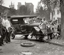 Washington, D.C., circa 1926. "Auto accident." With no shortage of witnesses. National Photo Company Collection glass negative. View full size.
Maybethe lamppost ran out and jumped on him?
Celebrity WatchIsn't that George Costanza standing next to the cop on the extreme left of the picture?
Slow Down, You Move Too FastThe missing running board and dented passenger door seem to indicate that a side impact threw this Durant into the lamppost.  Some other car apparently came kicking down the cobble stones.
How appropriate a headline, too, as my wife and I just saw Simon and Garfunkel at Jazz Fest in New Orleans this past weekend.  
Hello Lamppost:... feelin' not so groovy!
Whatcha knowin&#039;?He may have even kicked down a few cobblestones.
The good old daysThere was less government encroachment on personal liberty in the "good old days." That driver will be able to feel the effects of the accident for some time to come: he may even have scars or bruises to show family and friends. Today, however, the government requires us to wear seat belts: what a bummer.
[And our insurance premiums help pay for the liberty of you who choose not to. - Dave]
RubberneckingA good accident never fails to draw the attention of surrounding people. It is so interesting that boys would rather watch than play baseball!  
That tire on the groundis pretty thin!
High mileageThat certainly was a well worn tire that was knocked off the car. Maybe a blowout was the cause of the accident in the first place. 
Front EndHey, is that an indepentdent double wishbone suspension with anti-lock brakes and electronic stability control?
The air bag didn&#039;t deployDurant is in big trouble now!
Accidentes de tráficoNow climbing the charts at meneame.net.
(The Gallery, Cars, Trucks, Buses, D.C., Natl Photo)