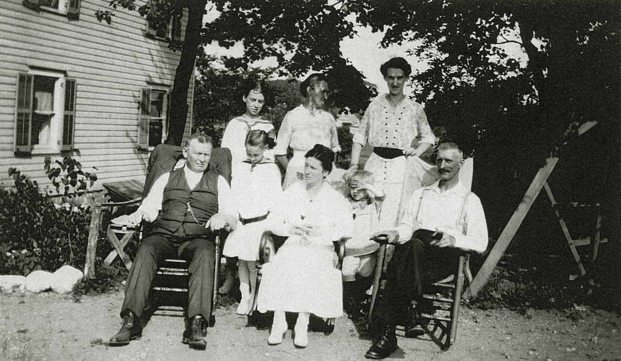 Tappan, New York, 1925. My grandmother, the tall person second row on the right, with her father in front of her, her father-in-law on the left front row and her mother-in-law  in the center. Her mother is to her right. The other two girls are her sisters. The small boy is her nephew. View full size.