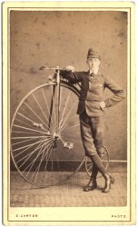 Circa 1874.  Albumen carte de visite.  An early clubman.  England.  Bike has an open head, spoon brake with straight handlebars.  Accessorised with a hub lamp.  Photographer is C. Carter. View full size.