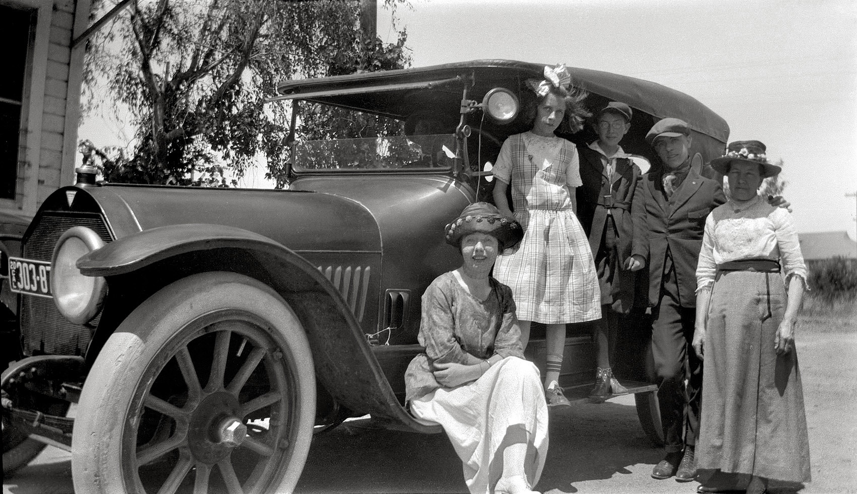 Members of my mother's family in Merced Falls, California, on an excursion from their home in San Francisco. Their family car is a 1914 Hudson 6-54. Standing on the running board, my mother and her twin brother Albert, with her older brother Francis and mother Marie standing at the right. Her father John is in the car, barely visible behind the windshield; oldest brother Jack drove, but isn't in this shot. Anna, a family friend, is seated on the running board. They're visiting my mother's older sister Mary, who had recently wed and moved to Merced Falls. View full size.

Family archives date this trip in the summer of 1919, although there's a 1920 license plate; I'm not sure how they were issued back then.

Some of these folks are also seen in a 1916 family portrait.

Scanned from original 2-1/2 X 4-1/4 116 roll film negative.