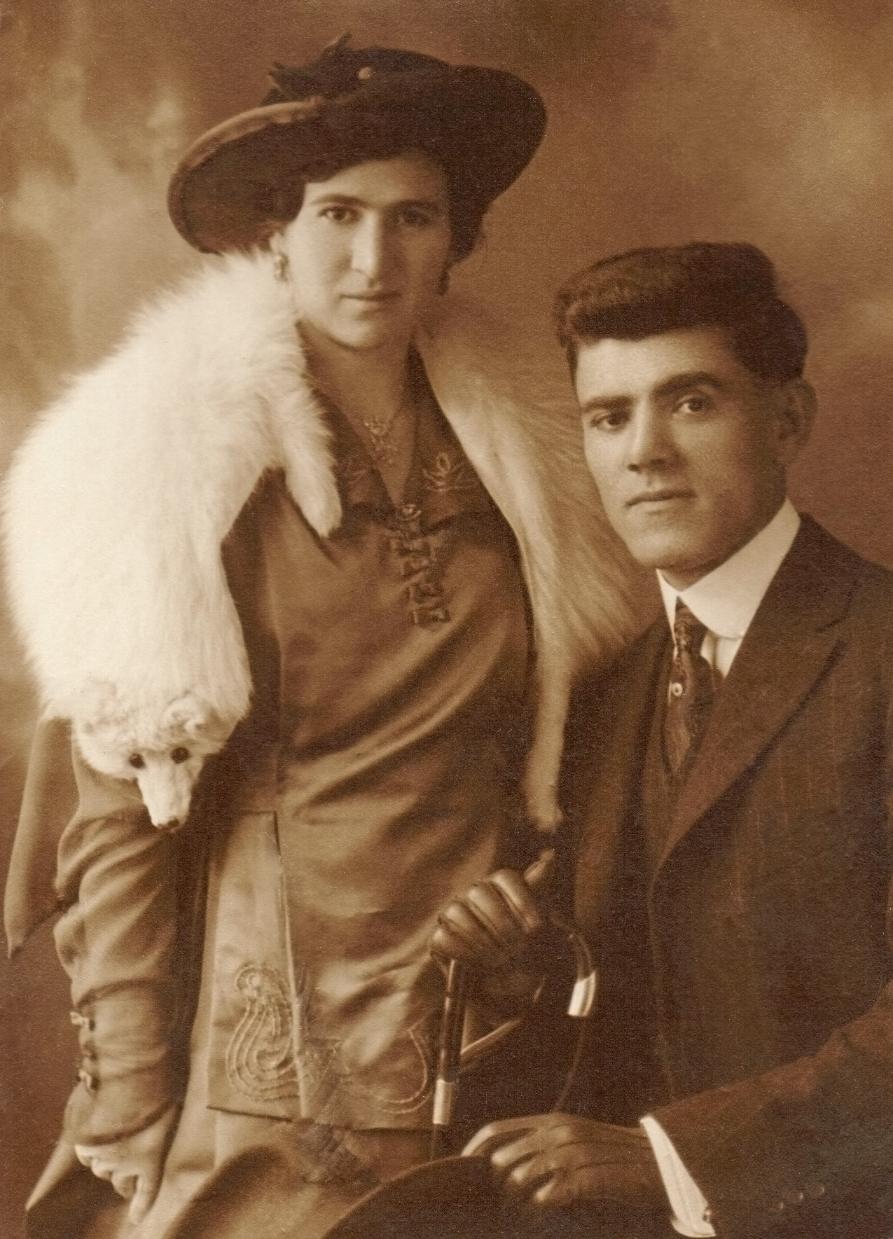 My maternal grandparents Rose and John Peshekerian were survivors of the Armenian holocaust, both having lost their parents to the Ottoman Turks. They met and married in California and later produced two daughters, one of whom was my mother. Both arrived in the United States with not much more than the clothes on their backs.

In relatively short order, though(perhaps 15 years), my grandfather became a successful San Francisco real estate broker. This photo from the 1920s (exact date unknown) is an obvious expression of them having "arrived." Both are dressed to the nines; both formally posed as husband and wife. 

Rose died of cancer in 1949, at the age of 56. John lived to be 93 years old and passed away, alone, in 1976 in San Francisco, never having remarried. View full size. 