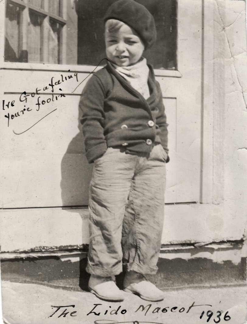 This is my Dad, aged 3, on vacation in Rockaway Beach, 1936. It was either my grandmother or grandfather who inscribed the popular hit song of 1936, "I've Got a Feelin' You're Foolin'" on the photo, as well as "The Lido Mascot" - Lido was the name of the family hotel in the Rockaways. 
Dad is dressed rather warmly for the Miami climate, which suggests it was indeed wintertime, and perhaps even chilly, even for these native New Yorkers. View full size.
