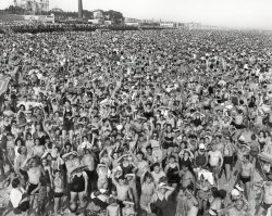 New York, 1940. "Crowd at Coney Island." Gelatin silver print by Arthur Fellig, the press photographer known as Weegee. View full size.
Fourth of July WeekendI was 8 my that year &amp; mom had taken me to Coney Island beach since I was an infant.  If this was the Fourth of July it marks the last time she put up with the crowds that were there (weather permitting) most every week end in July and August.
After that it was Sunset Park Pool across the street from our third floor front apartment at 4109 7th Avenue in Bayridge, Brooklyn. No need for trolleys, subways and body odors.
Kids who today think Woodstock and rock concerts in Central Park were huge should see this photo. I demonstrated in four "marches" on Washington and they couldn't hold a candle to this loony mass of humanity.
In Living ColorA colorized version of this photo would be nice. Anyone up to the task?
Where is WaldoBlack-and-white version.
WoodstockThat was my first impression upon seeing the preview.
Okay, Harry, where do we set up the tent?My one day spent at Coney Island Beach in 1958 or so was enough for a lifetime, and our subsequent outings to the beach at nearby (Jacob) Riis Park were far more pleasant, although I never became a big fan of beaches anywhere. 
The ride home on the bus and subway while still encrusted in sand and salt was truly the low point of every trip.
Reminds me of:Where's Waldo.
Yogi Berra&#039;s Quote“Nobody goes to Coney Island anymore, it's too crowded.”
Small wonder, and he actually may have said it. However, he also is said to have said, “I never said most of the things I said.”
Auntie Mary and cousin Joe in the tenth row back?How many megapixels to get that level of detail on this here newfangled digital film, then?
Washrooms?Oh, the ocean.  (I'm assuming it's there somewhere.)
Special event?That can't have just been the regular Tuesday crowd, right? There had to have been something special happening that day, to have so many packed in like sardines ....
It was so very hot on that day.None of the rides were open and Mister Handwerker ran out of red hots.
Me?!?!jobaron
I am somewhere in this picture. I grew up in Coney Island and, since this was taken on the Fourth of July, 1940, I most certainly am somewhere here. No way I wasn't on the beach that day...
Anybody find me?
:-)
How many humans?Wow. Do that many people ever get together in one place any more? I know I have never been in a crowd that big in my life! Does Coney Island still get this overcrowded? Is the entire meyro NYC there all at the same time?
to heck with Where&#039;s Waldo.Where's the water? It will take all day to find it.
Show Us Your PitsI'll just show myself out now.
No ExitSometimes it's nice just to get away from it all and go to the seashore
Watch the birdieThe trick here seems to be: How do I get them to look at me?
The Wonderwheel still stands and operates, as does the Cyclone, as far as I'm concerned the finest wooden rollercoaster in use.
I once got paid to ride it for an audio experiment, and made 23 trips around it with a 24 pound tape recorder in my lap.  
I was a huge bruise the next day.
They said my headphones flew off at one point and I calmly reached into space and grabbed them.  What a great day.
So Ralphie said"Why don't we go to the beach and get out of this hot, crowded city?"
SunblindnessSomeone could have made a fortune selling sunglasses to this crowd... I only count about a dozen or so folks wearing eye protection. Today you'd only be able to count a dozen or so NOT wearing sunglasses! 
What a crowd! I'm getting claustrophobic just looking at the photo! 
A sea of humanityWonder what the occasion was?  It's hard to believe there's enough room for anyone there to enjoy a peaceful day at the beach.
Must have been a change for Weegee -- shooting live subjects, that is.  Most of his photos I've seen are still life (or, more accurately, still "death")
&quot;Let&#039;s Go Down On The Sand,&quot;"It has to be less crowded than this boardwalk is...."
My Dog Filmed a Short Film on that BeachMy dog filmed a video on the boardwalk and on the beach in this photo.  We rode the Wonder Wheel together and also had our photo taken in a photo booth.  He died on Oct. 18, 2015 at age 15.
RIP Clancy :(
https://www.youtube.com/watch?v=a_CaQqDSRu4
Listen Without PrejudiceI always wondered where this picture was from! George Michael used it for the cover of his "Listen Without Prejudice, Vol. 1." and I always thought the woman in the center in the black bikini looked like my English teacher. Clearly, she was not; I'm not quite that old.
East Coast For Sure!You can count the blondes on one hand!
Good dayto head out to Flushing Meadows to the World's Fair!
J. Edgar HooverMr Cool in the lower right corner cracks me up; he even wears fedora and sunglasses in the shower.
Any open space will doWhere can I lay out my towel? Has anyone seen my flip-flops?
What kind of drive would one have to go to such a place where you could hardly breathe? Like someone said..."where's the water?"
Where Are They?So how did those folks find their blanket after the photo? That is one huge group of people. 
Was Coney Island Segregated Then?I see only shades of white and sunburned.
Re: WoodstockYep, pretty close!
This might make a good source for colorizers, too...
Oh, the Humanity!My guess is 600 to 700 thousand people framed in the pic. About enough to fill 9 football stadiums.
Ideal PlaceIf you ever wanted to lose a kid this would be where to do it!
Anyone who&#039;s gotta use the washroomraise your hand.
July 28, 4 p.m.Which was a Sunday.  (Found with reference to a 2009 exhibition at the Spencer Museum of Art at the University of Kansas which included this photo.)
THE RIDE HOME?!!!!!I will NEVER complain about a crowd and traffic again.  I have never seen anything like this before.
The comment volume..........is proportional to the amount of exposed skin. Of course, there is also a female coefficient to factor in when applicable.  
Where are Mom&#039;s shoes?I was born in Coney but went to neighboring Brighton Beach. On one of those hot days, with blanket touching blanket staking our space, a crowd started to gather as someone was drowning. After things calmed down my mom discovered that someone took her shoes. I was about 12 but remember it as if it were yesterday as she walked to the train without shoes. Oh the memory that this photo stirred up. Thanks
Looking back.Imagine the heebie-jeebies this gathering would now conjure, with the pandemic we're facing.
Social distancing 1940 style.
(The Gallery, Coney Island, NYC, Swimming)