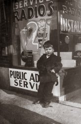 My dad at six years old. Taken at 14342 Kercheval in Detroit. My Grandpa Breen owned this radio store. The family lived in the upper flat. He was also a sign painter and did his own window signage. View full size.
(ShorpyBlog, Member Gallery)