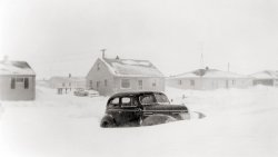 March 1959. This is my mother's 1939 Plymouth in our driveway being slowly buried during a "spring" snowstorm in Neenah, WI.  I believe my father snapped this photo from the comfort of our living room with his trusty Brownie.

Image captured approximately here.