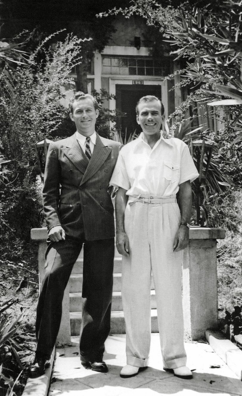 I found this photo, which is dated 1939, in an antique store in Simi Valley, California. It is glued to an album page labeled "House of Chords and Dischords." The picture of that house, which is labeled 1961 N Argyle, is missing. But under these two gentlemen it says "2 inmates." View full size.
