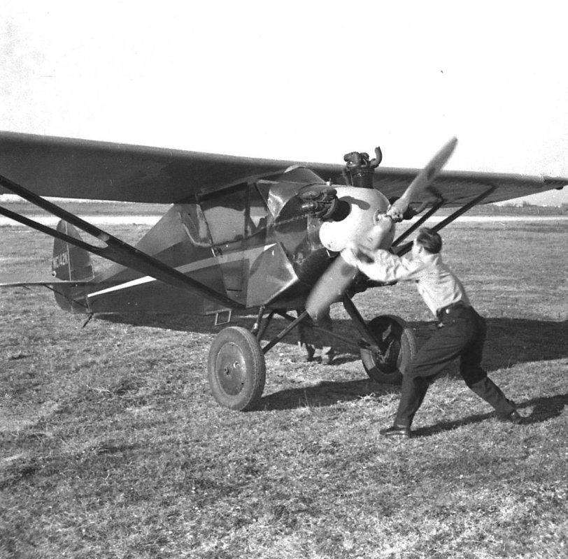 My father, Lee Clough, in 1939, pulling to start his Monosport aircraft at Scholes Field, Galveston's airport. It's fun when your father owns a flying school. Photo likely by my grandfather, George Roy Clough. View full size.
