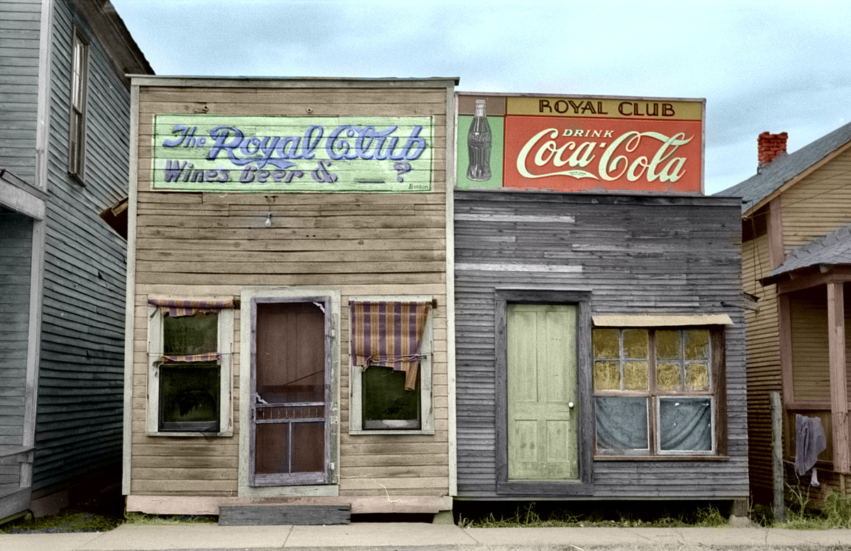 A colorized version of this 1939 photo by Russell Lee of storefronts in Mound Bayou, Mississippi. View full size.