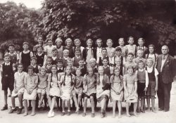 My Mom's class photograph from 1943. My Mom is the barefoot girl on on the right hand side.
