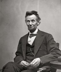 February 5, 1865. "Abraham Lincoln, seated, holding spectacles and a pencil." Glass transparency; photograph by Alexander Gardner. View full size.