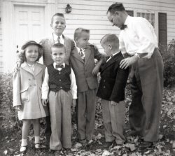 Here's Dad setting up a shot of myself (looking at the camera in front) and my brothers, with visiting family friends during the summer of 1957. Bedford, Quebec. It was apparently a Sunday, likely after church, with us all in our best.
