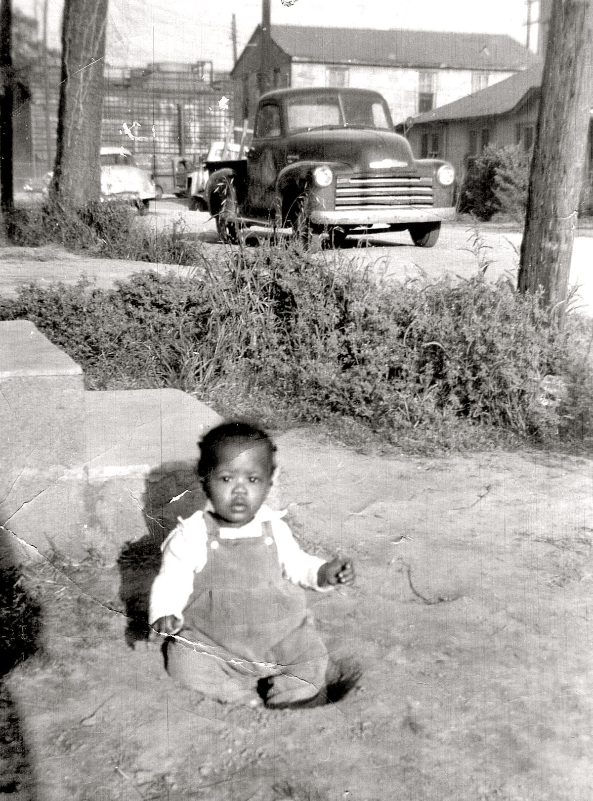 Me, approx. age 2 in 1957, Laurel, Mississippi. The Masonite plant looms in the background. View full size.