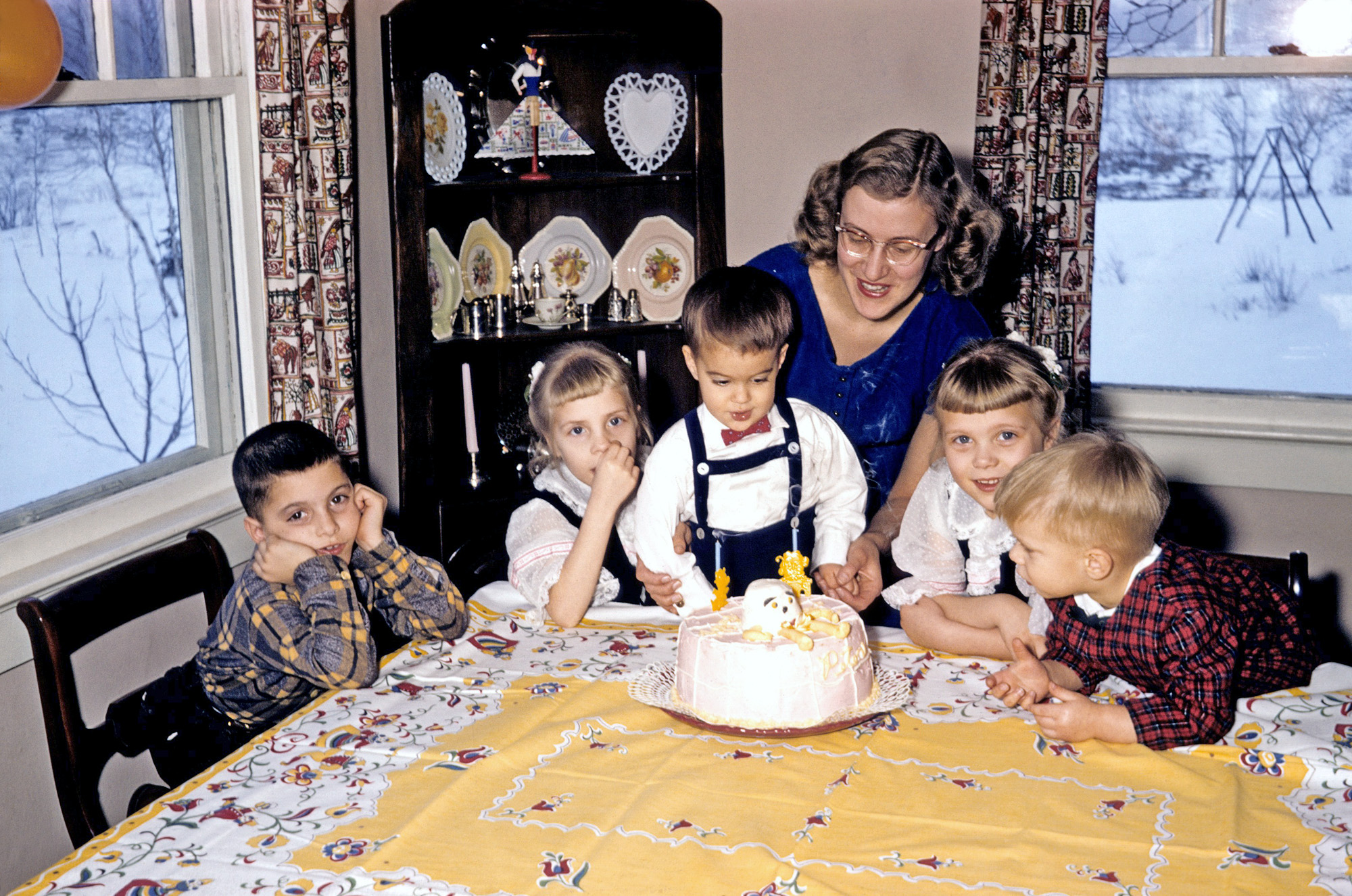 March 1958, my older brother's second birthday. Octopus (no: I'm emending this to Humpty Dumpty) cake, with cousins surrounding. Folksy decor. Is the folksiness peculiar to my parents, who were international folk dancers? Or was it generally popular in that era? Bow ties. Kodachrome, taken on Minolta A range-finder. I've also posted a picture from his birthday a year earlier. View full size.