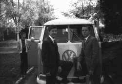 My brother Tom, Me (with the crooked smile) and my brother Bob in front of our 1962 VW Kombi bus.  This is the second VW bus my parents owned. The first, a red and white microbus was fancier than this model. We are getting ready to go to my grandmother's house for Easter dinner. Back in those days we all got dressed up for Sunday dinner.
Tom lives in St. Augustine, Bob lives in Tampa and I live in Springfield MO.  All three of us have owned VWs of one form or another in our lives.  One time my dad owned a Citroen DS19 Palais, which seemed to be constantly on a trailer to KCMO to get repaired. He finally sponsored a 'boat person' who was a Citroen mechanic in Saigon. After that, the car ran like a top. View full size.
Valuable!Depending on the condition that bus would be worth a mint these days!
Bus colourDonning my VW anorak, and zipping it right up,I think I can guess the colour of this Kombi. Was it Pearl White over Mouse Grey?  Turquoise was another option for this year but it looks too dark for that.
(ShorpyBlog, Member Gallery)