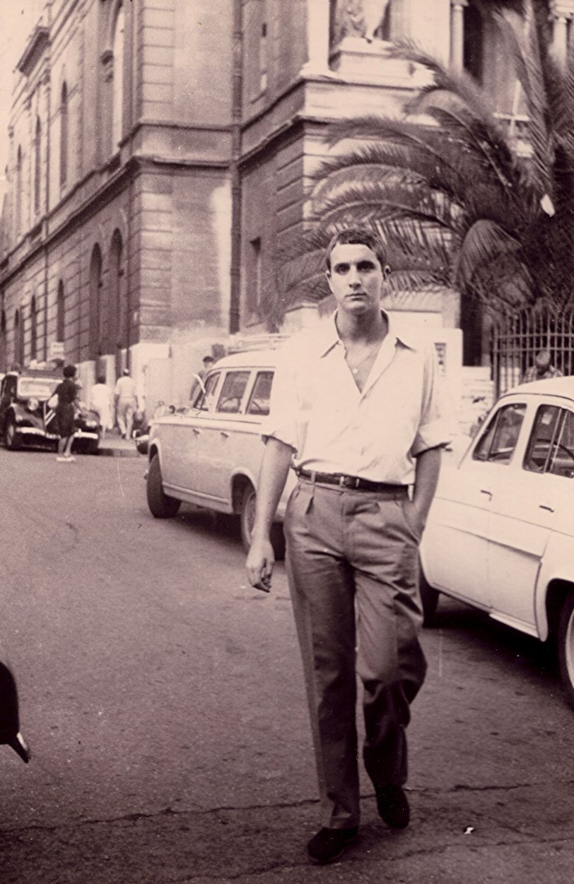 My father Robert was born in Toulon (South of France). Here he is walking in a street in Toulon in 1962 looking like a movie actor. 
