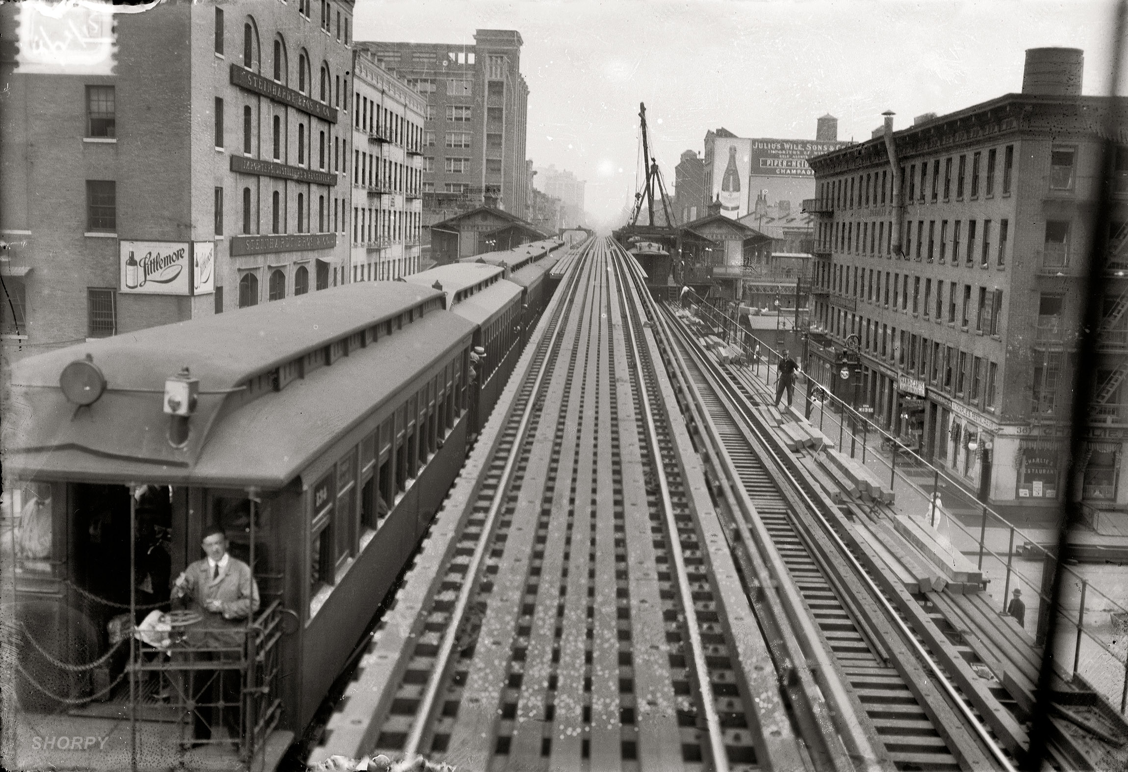 August 21, 1915. "Express track, 9th Avenue 'L'." Construction along the Ninth Avenue elevated tracks at West 13th Street in New York. On the corner: Charlie's Restaurant. 5x7 glass negative by George Grantham Bain. View full size.