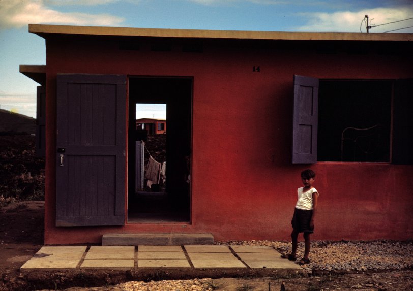 December 1941 or January 1942. "Child of a Farm Security Administration rural rehabilitation borrower in front of his house in Puerto Rico." 35mm Kodachrome transparency by Jack Delano for the FSA. View full size.
