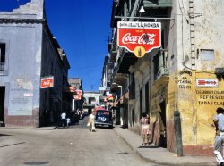 Street in San Juan, Puerto Rico, December 1941. View full size. 4x5 Kodachrome transparency by Jack Delano, who moved to Puerto Rico permanently in 1946. The cross street is Calle de Rafael Cordero and the street we're looking down is Calle de Dr. Jose C. Barb-- with the last few letters obscured.