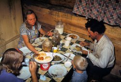 The Faro Caudill family eating dinner in their dugout, Pie Town, New Mexico. October 1940. 35mm Kodachrome transparency by Russell Lee. View full size.