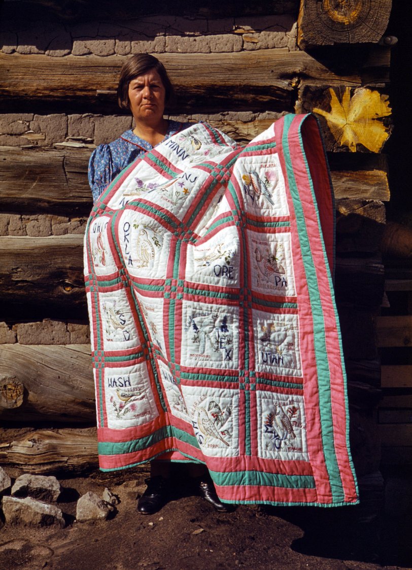 Mrs. Stagg helps her husband in the field with plowing, planting, weeding corn and harvesting beans. She quilts while she rests during the noon hour. Pie Town, N.M. October 1940. View full size. 35mm Kodachrome transparency by Russell Lee.
