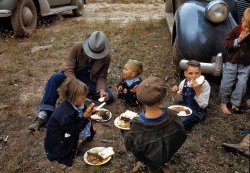 September 1940. "Homesteader and his children eating barbeque at the Pie Town, New Mexico Fair." Kodachrome transparency by Russell Lee. View full size.