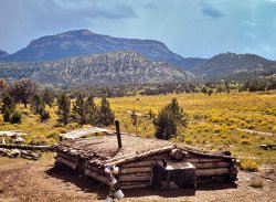 October 1940. Dugout house of homesteaders Faro and Doris Caudill with Mount Allegro in the background. Pie Town, New Mexico. The Caudills at dinner. 35mm Kodachrome transparency by Russell Lee. View full size.