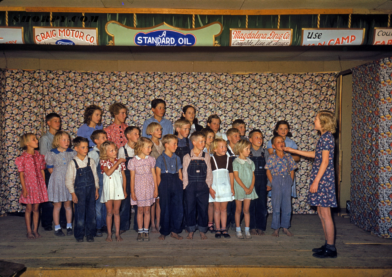 Pie Town schoolchildren singing. October 1940. View full size. 35mm Kodachrome by Russell Lee. Second boy from the right is "Pops" McKee, interviewed by Paul Hendrickson in the Smithsonian article on Pie Town.