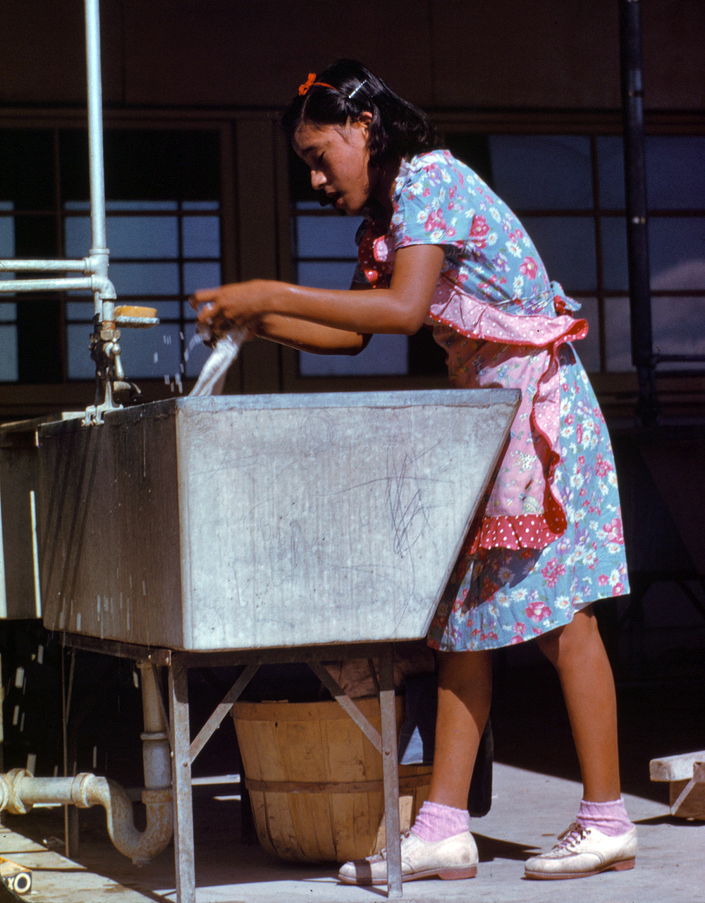 January 1942. Young woman at the community laundry Saturday afternoon. Farm Security Administration camp at Robstown, Texas. View full size. 35mm Kodachrome transparency by Arthur Rothstein for the FSA.