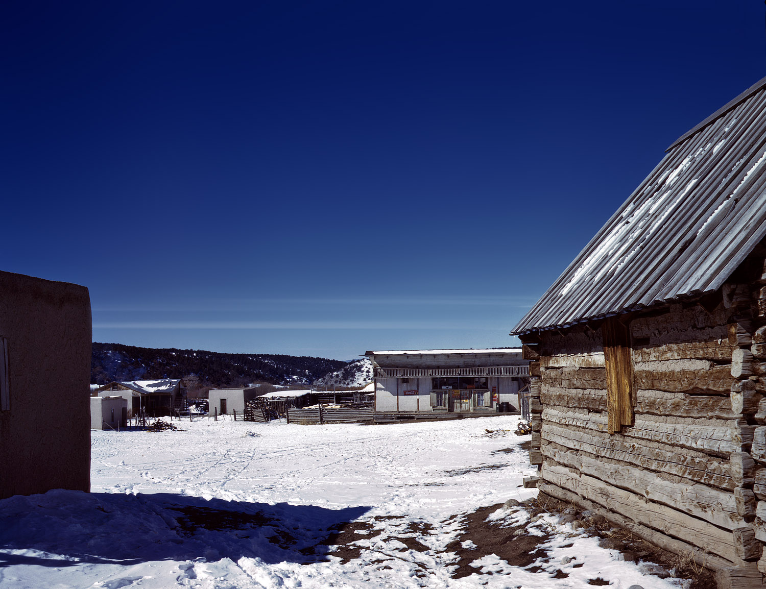 January 1943. Store and plaza in the village of Trampas, Taos County, New Mexico. View full size. 4x5 Kodachrome transparency by John Collier.