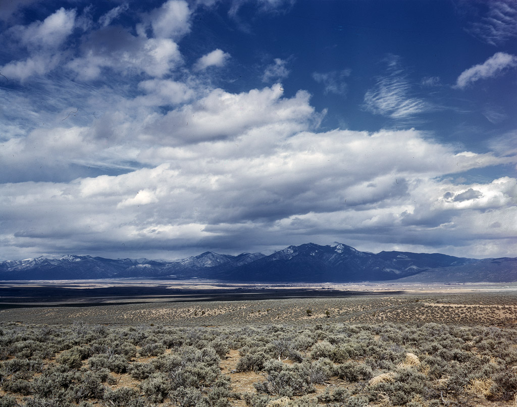 Sagebrush and mountains in northern New Mexico, 1943. View full size. 4x5 Kodachrome transparency by John Collier.