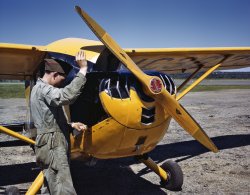 Ground crew making a routine overhaul of a Civil Air Patrol plane (Stinson 10A) at base headquarters of Coastal Patrol #20, Bar Harbor, Maine. June 1943. View full size. Kodachrome transparency by John Collier.