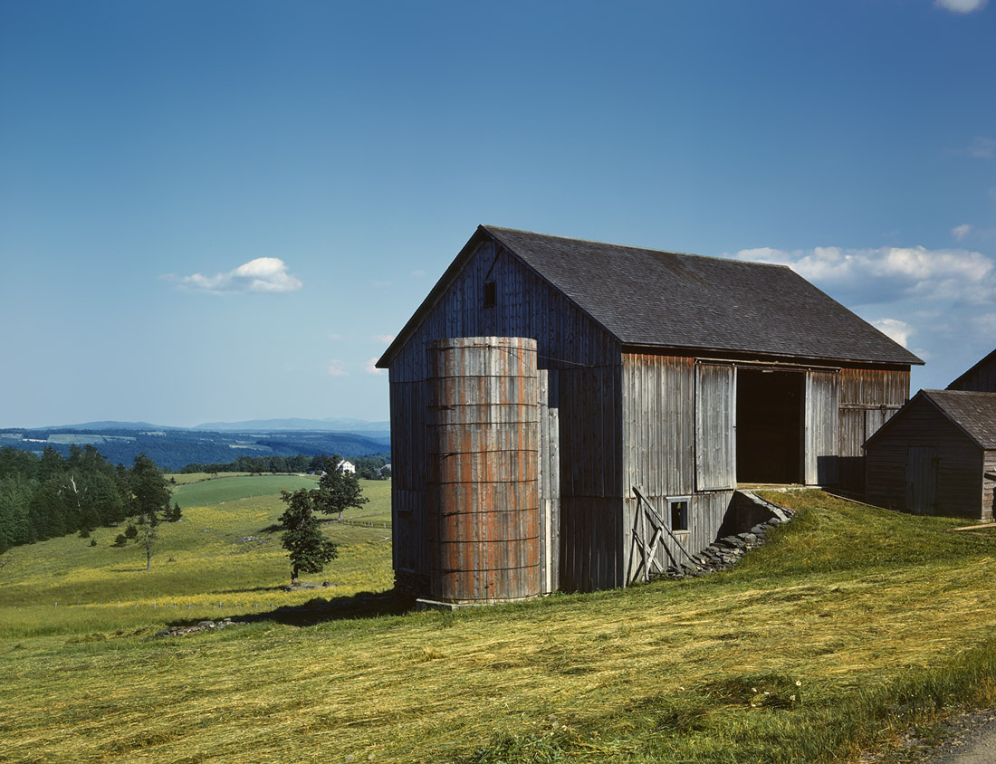 Farmland and weathered barn in the Catskill country, New York State. June 1943. View full size. 4x5 Kodachrome transparency by John Collier.