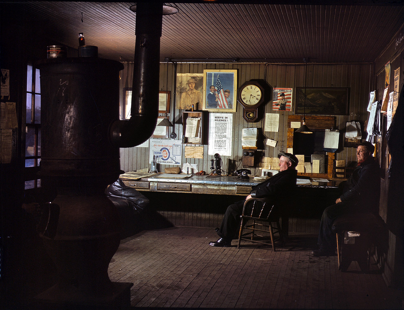 December 1942. A winter afternoon in the North Proviso yardmaster's office, Chicago & North Western Railroad. View full size. 4x5 Kodachrome transparency by Jack Delano. Click here for a closeup of the poster on the wall.