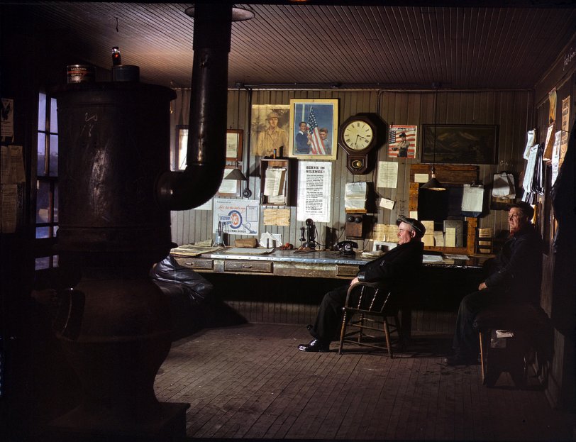 December 1942. A winter afternoon in the North Proviso yardmaster's office, Chicago &amp; North Western Railroad. View full size. 4x5 Kodachrome transparency by Jack Delano. Click here for a closeup of the poster on the wall.

