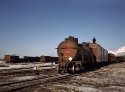 December 1942. Proviso Yard, Chicago & North Western R.R. "A train, or 'cut,' being pushed out of a receiving yard toward the hump. A brakeman rides each train to signal the engineer in the locomotive at the rear." View full size. 4x5 Kodachrome transparency by Jack Delano, Office of War Information.