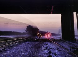 December 1942. Chicago, Illinois. "View in a departure yard at Chicago & North Western's Proviso yard at twilight. Brakeman is signaling with a red flare and the train is going by during exposure." Kodachrome by Jack Delano. View full size.