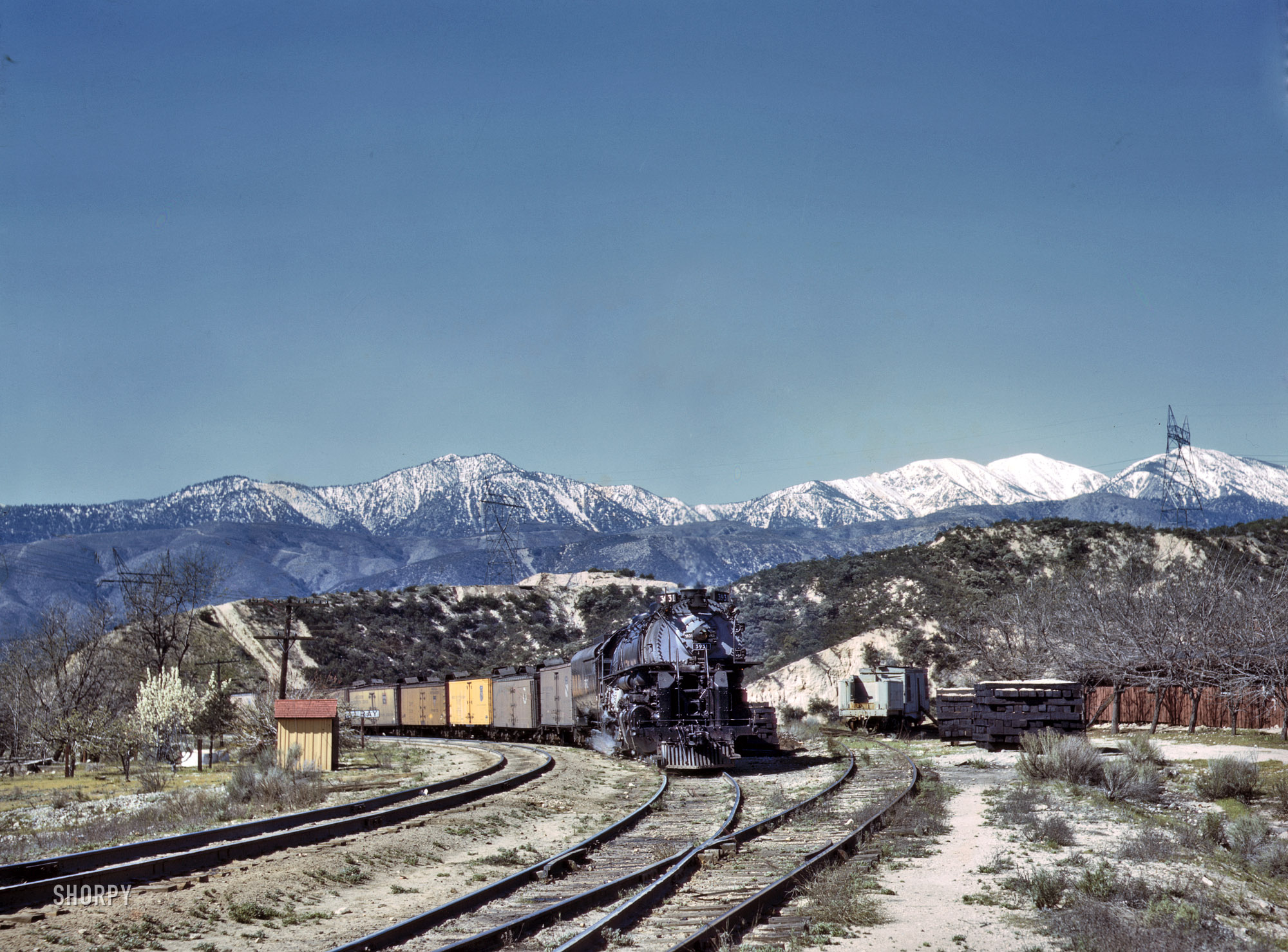 March 1943. "An eastbound Union Pacific freight waiting in a siding at Alray, California. Coming up through Cajon Pass. The Santa Fe tracks are used by the Union Pacific as far east as Daggett, Calif." One of many images taken by Jack Delano documenting a Santa Fe freight train's journey from Chicago to California. 4x5 Kodachrome transparency. Office of War Information. View full size.