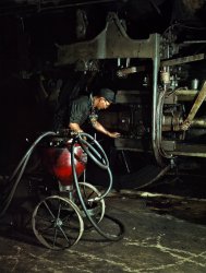 Thomas Madrigal greasing a locomotive in the roundhouse, Rock Island R.R., Blue Island, Ill. April 1943. View full size. 4x5 Kodachrome transparency by Jack Delano for the Office of War Information.