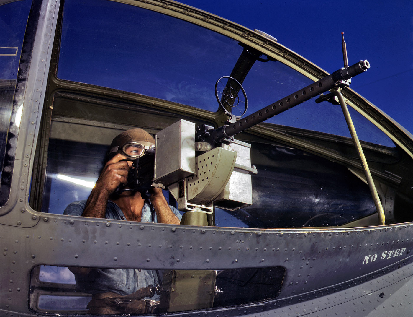 Another shot of AOM Jesse Rhodes Waller and machine gun in a PBY Catalina at Corpus Christi Naval Air Base in August 1942. View full size. 4x5 Kodachrome transparency by Howard Hollem for the Office of War Information.