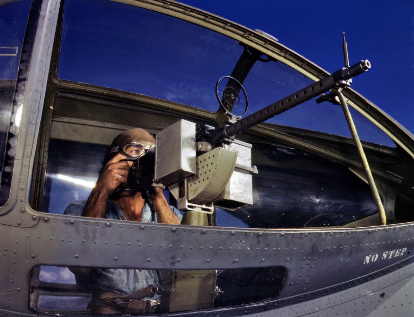 Another shot of AOM Jesse Rhodes Waller and machine gun in a PBY Catalina at Corpus Christi Naval Air Base in August 1942. View full size. 4x5 Kodachrome transparency by Howard Hollem for the Office of War Information.
