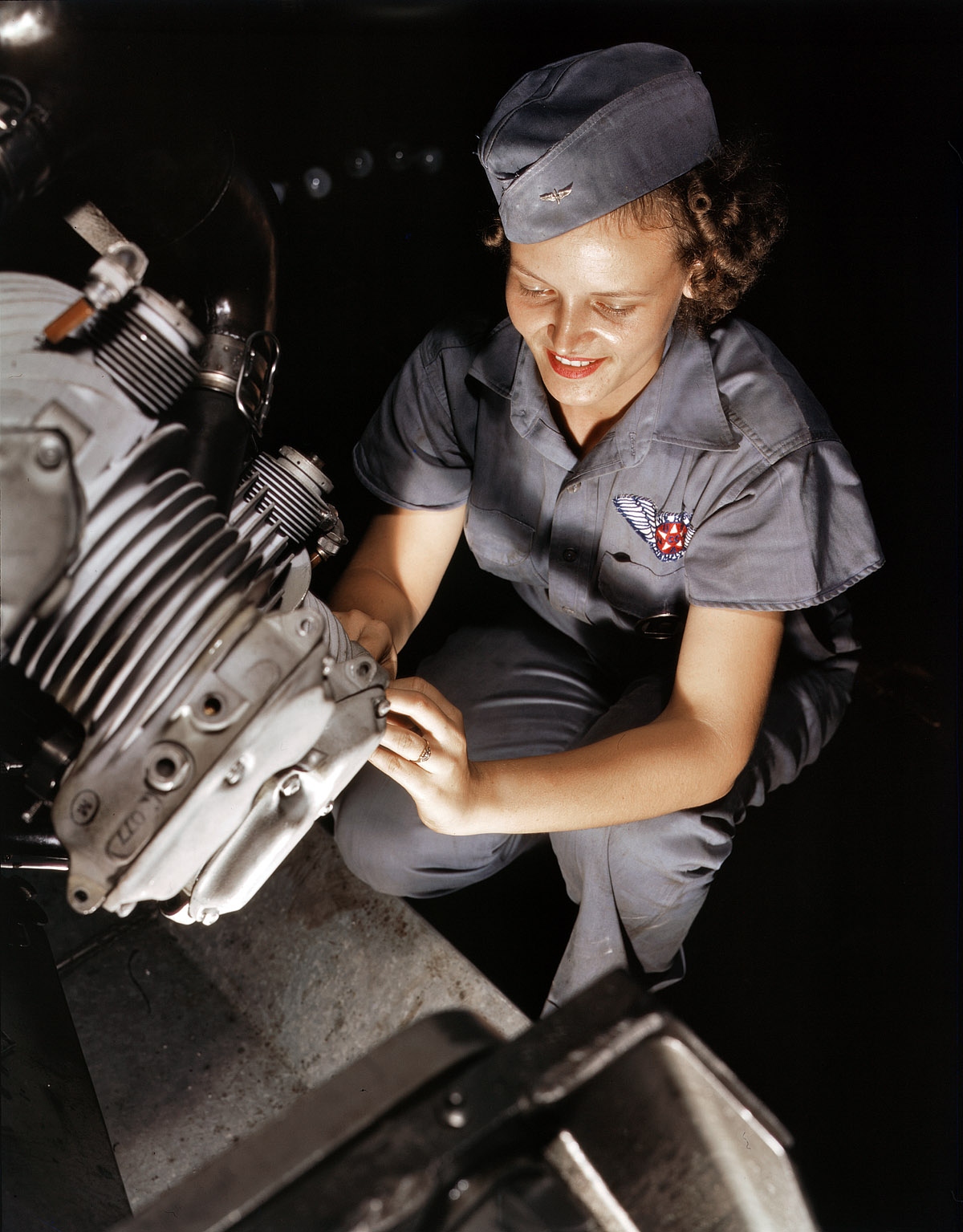 August 1942. Mechanic Mary Josephine Farley works on a Wright Whirlwind motor in the Corpus Christi, Texas, Naval Air Base assembly and repairs shop. View full size. 4x5 Kodachrome transparency by Howard R. Hollem.