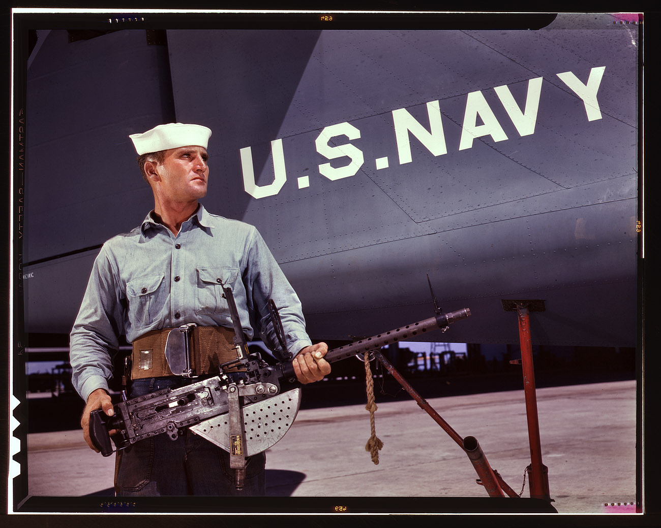 August 1942. Corpus Christi, Texas. "After seven years in the Navy, J.D. Estes is considered an old sea salt by his mates at the Naval Air Base." View full size. 4x5 Kodachrome transparency by Howard Hollem, Office of War Information.