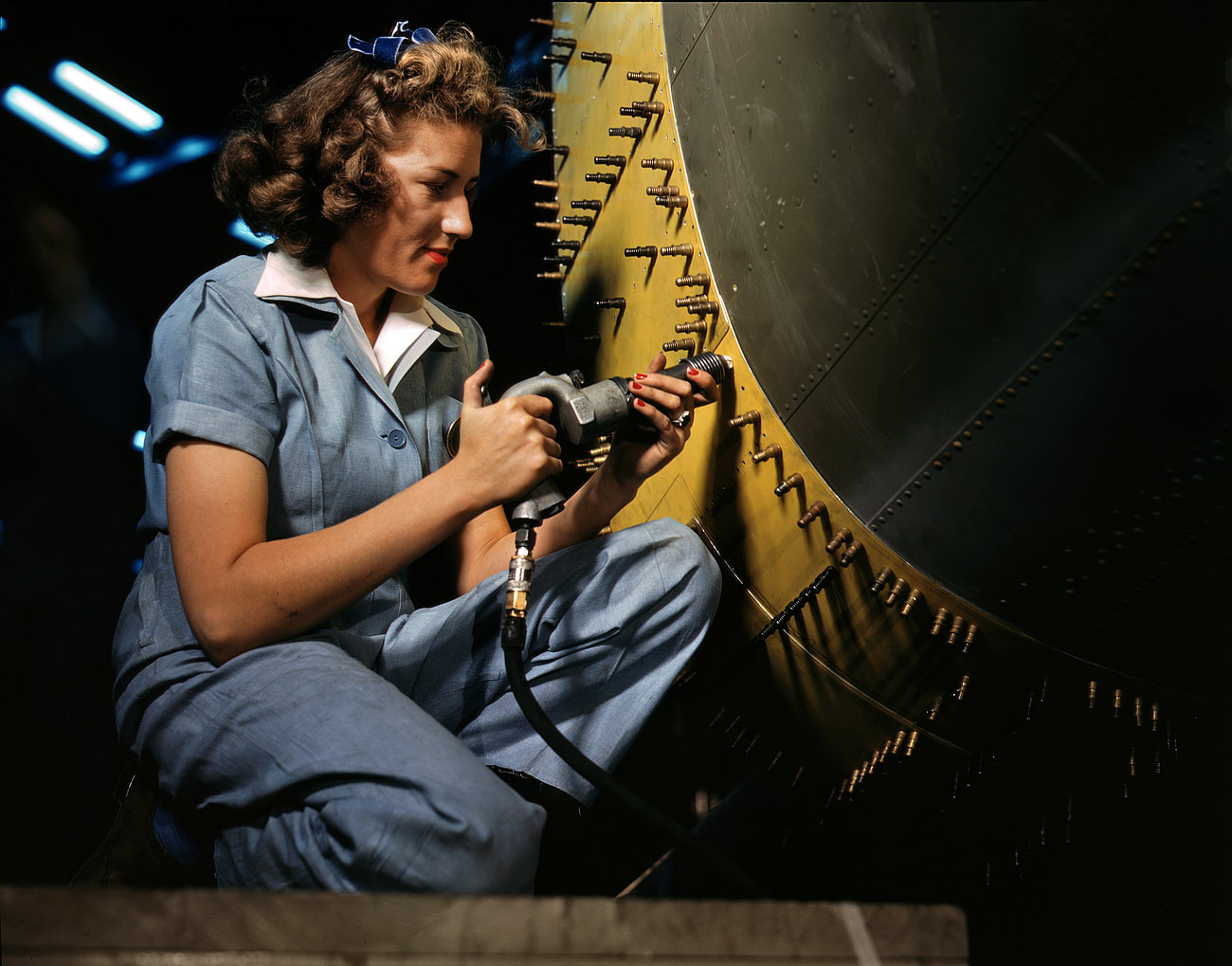 October 1942. Riveter at work on a bomber at the Consolidated Aircraft factory in Fort Worth. View full size. 4x5 Kodachrome transparency by Howard Hollem.