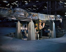 Wing center section of a Liberator bomber at the Consolidated Aircraft plant. October 1942. View full size. Kodachrome transparency by Howard Hollem.