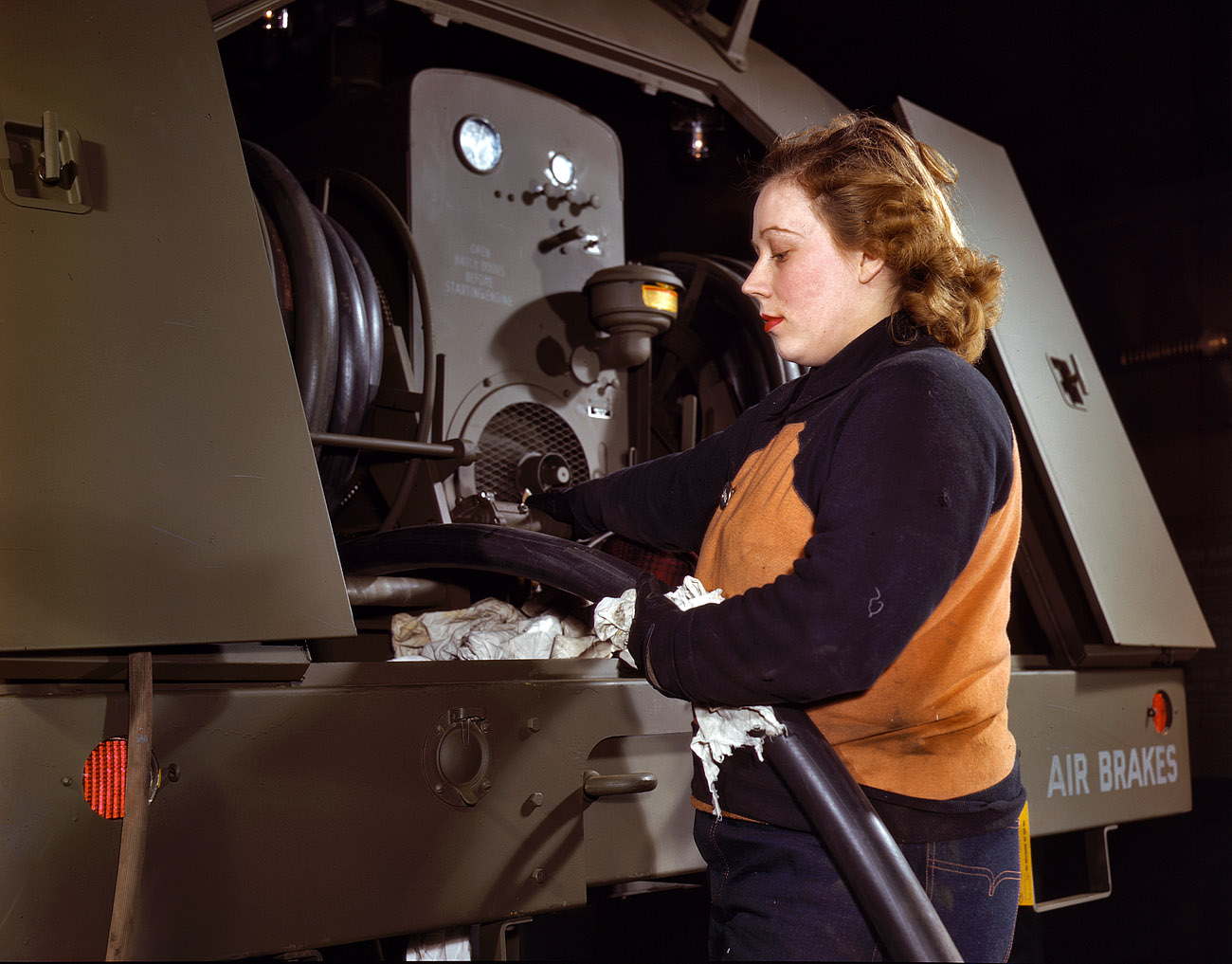 February 1943. Heil & Co., Milwaukee. "Agnes Cliemka, age 23, husband may be going into the service any day. Agnes used to work in a department store. Checking fuel hose on gasoline trailer before it is turned over to the Air Force." 4x5 Kodachrome transparency by Howard Hollem. View full size.