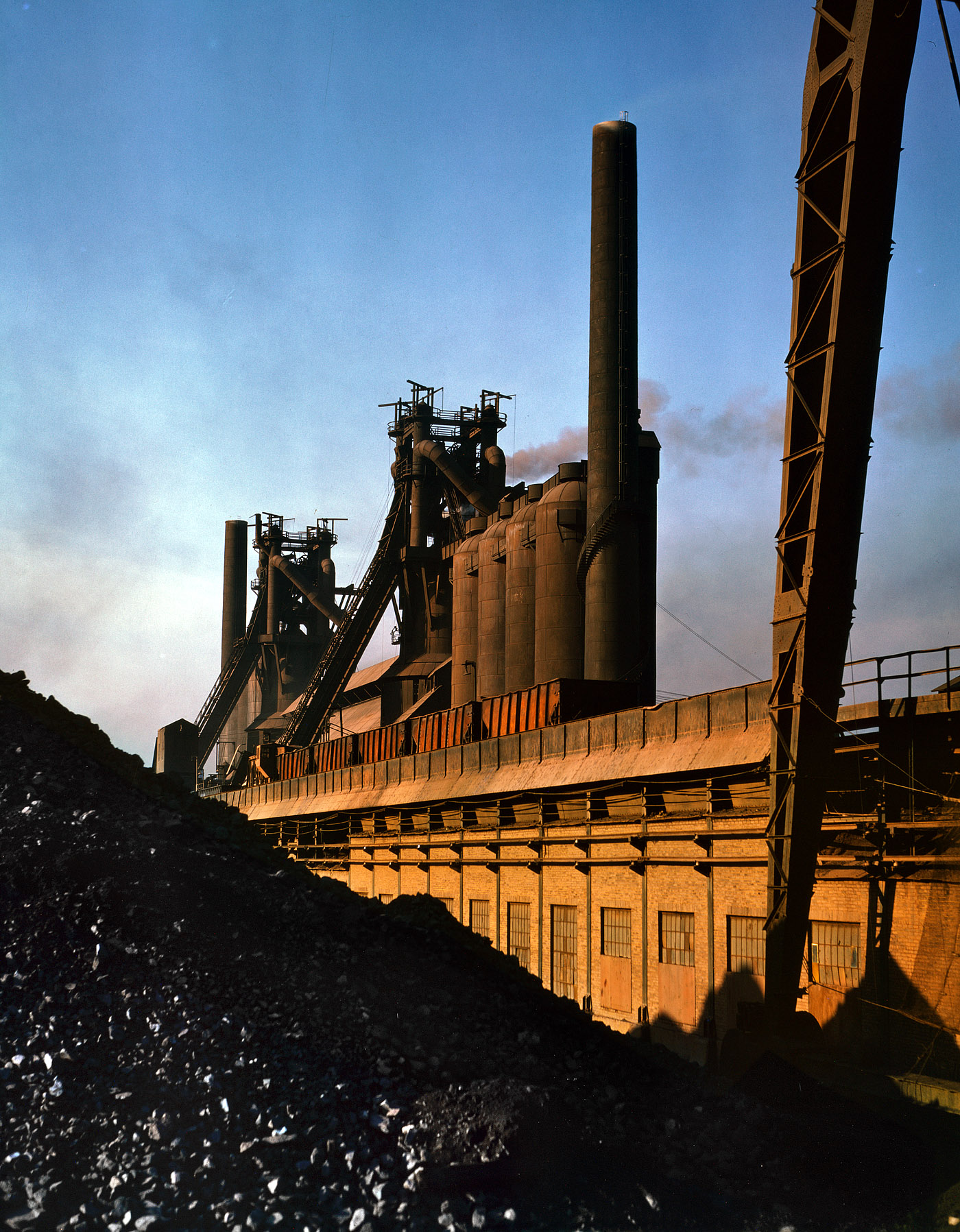 Nov. 1941. Etna, Pennsylvania. "Blast furnaces and ore at the Carnegie-Illinois Steel mills." View full size. 4x5 Kodachrome transparency by Alfred Palmer.