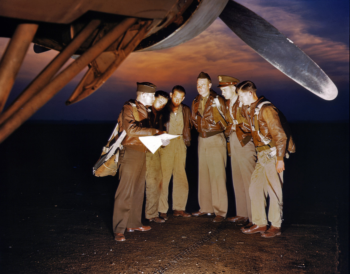 May 1942. "Here's our mission." A combat crew receives final instructions just before taking off in a mighty YB-17 bomber from the bombardment squadron base at Langley Field, Virginia, nation's oldest air base. View full size. 4x5 Kodachrome transparency by Alfred Palmer for the Office of War Information.