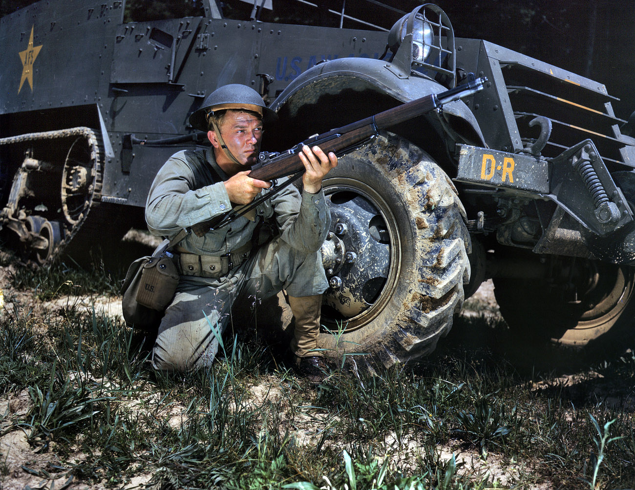 June 1942. Fort Knox, Kentucky. "Infantryman with halftrack. A young soldier sights his Garand rifle like an old-timer. He likes the piece for its fine firing qualities and its rugged, dependable mechanism." 4x5 Kodachrome transparency by Alfred Palmer for the Office of War Information. View full size.