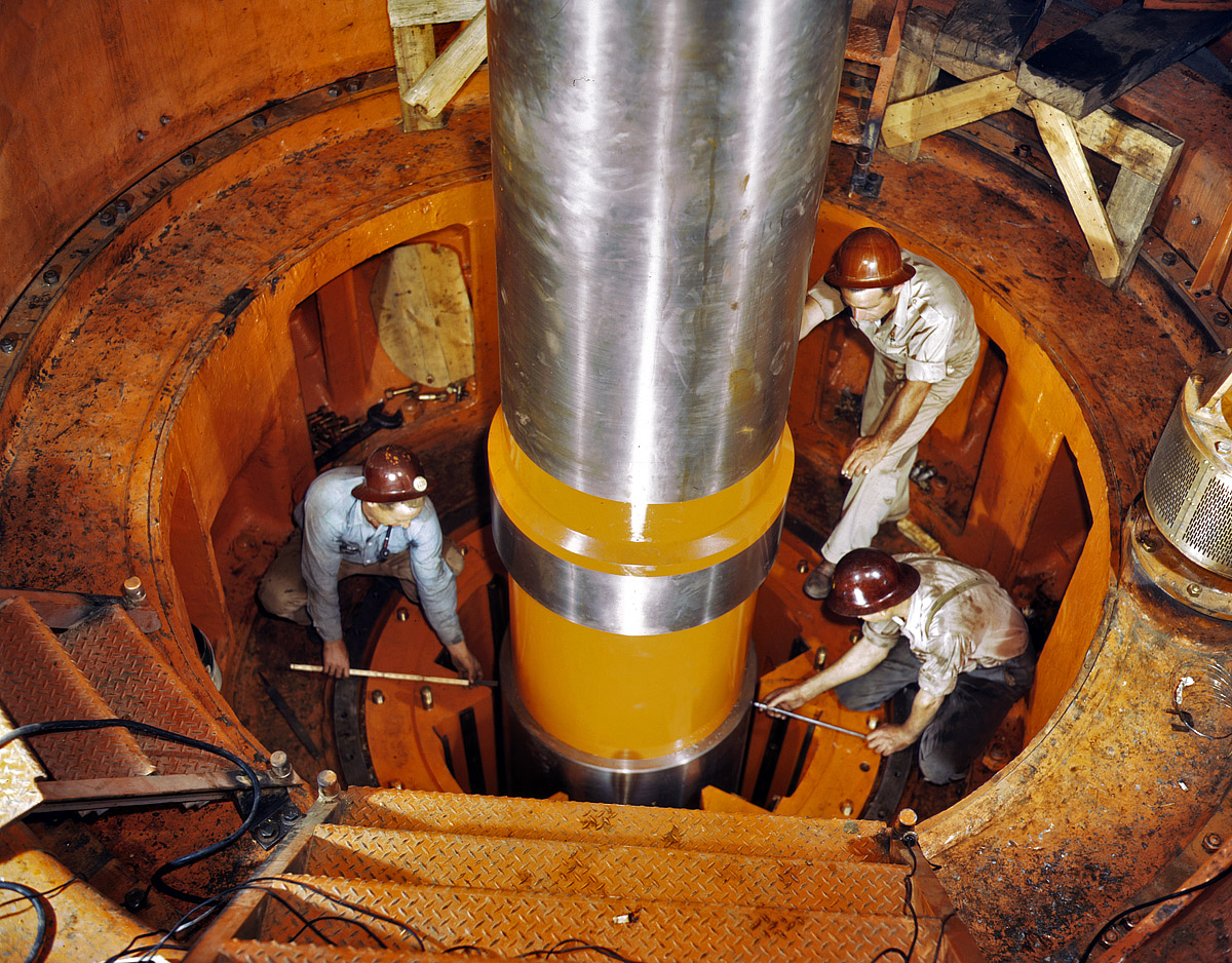 June 1942. Checking the alignment of a turbine shaft at the top of the guide bearing in the TVA hydroelectric plant at Watts Bar Dam, Tennessee. View full size. 4x5 Kodachrome transparency by Alfred Palmer.